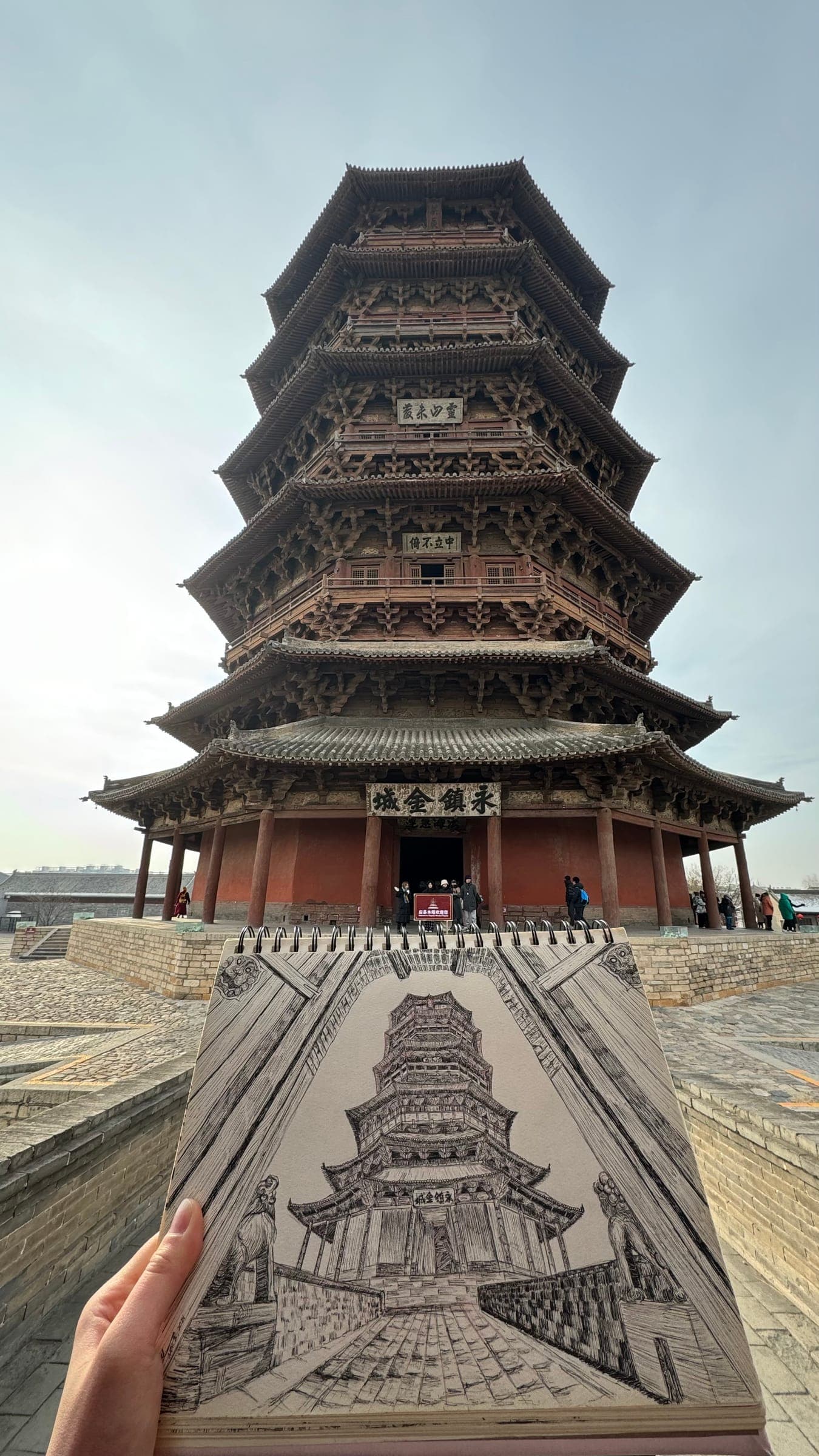 A sketch of Yingxian Wooden Pagoda held in front of the pagoda